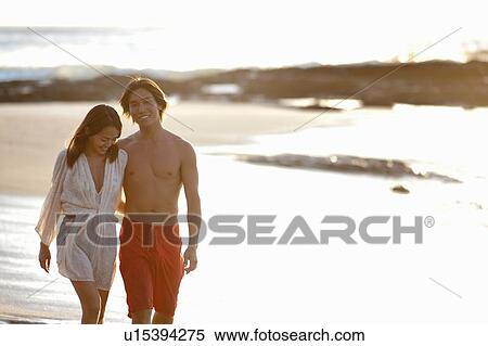 Couple walking together on beach View Large Photo Image Stock Photography - Couple walking together on beach. Fotosearch
