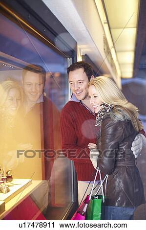 Stock Image - Couple window shopping together. Fotosearch