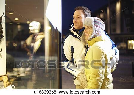 Couple window shopping together View Large Photo Image Stock Photo - Couple window shopping together. Fotosearch