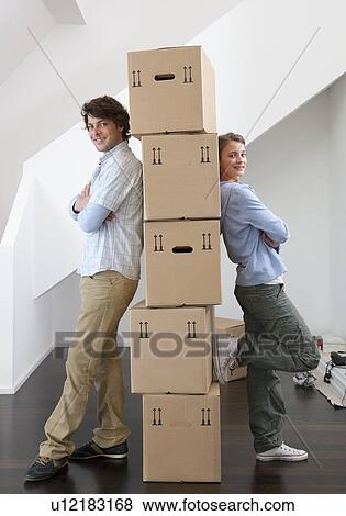 Stock Photo - Couple with stack of cardboard boxes. Fotosearch