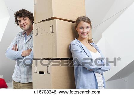 Stock Photograph - Couple with stack of cardboard boxes. Fotosearch