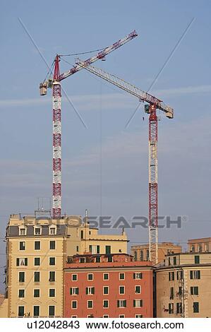 Cranes over urban apartment buildings View Large Photo Image Stock Image - Cranes over urban apartment buildings. Fotosearch