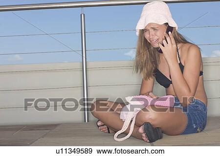 Stock Photo - Crying teenage girl on cell phone. Fotosearch