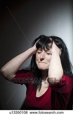 Crying woman clutching her head View Large Photo Image Stock Photo - Crying woman clutching her head. Fotosearch