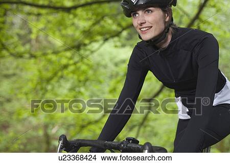 Cyclist biking in park View Large Photo Image Picture - Cyclist biking in park. Fotosearch