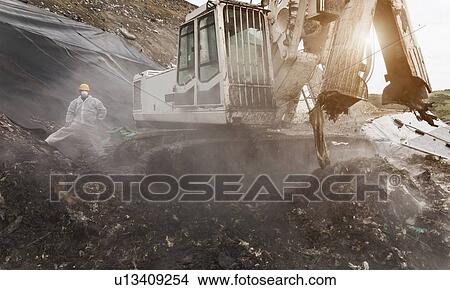 Digger at garbage collection center View Large Photo Image Picture - Digger at garbage collection center. Fotosearch