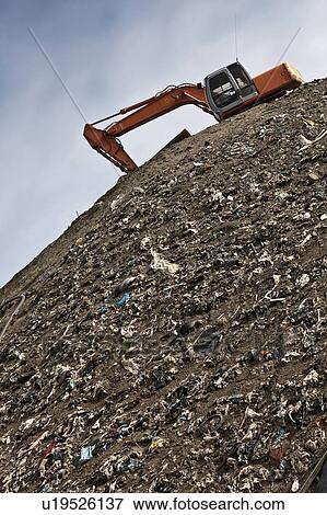 Digger at garbage collection center View Large Photo Image Stock Photo - Digger at garbage collection center. Fotosearch