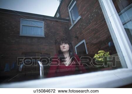 Disappointed woman standing in kitchen View Large Photo Image Stock Image - Disappointed woman standing in kitchen. Fotosearch
