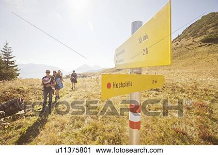 Stock Image - Family hiking on rural trail. Fotosearch