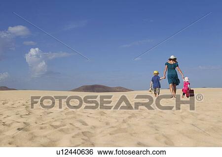 Stock Photograph - Family walking together on beach. Fotosearch