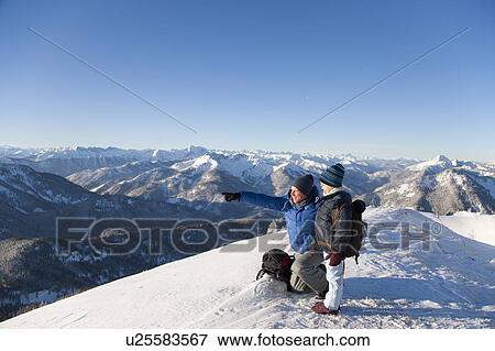 Father and son surveying snowy landscape View Large Photo Image Stock Photo - Father and son surveying snowy landscape. Fotosearch
