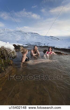 Friends relaxing in glacial hot spring View Large Photo Image Stock Photo - Friends relaxing in glacial hot spring. Fotosearch