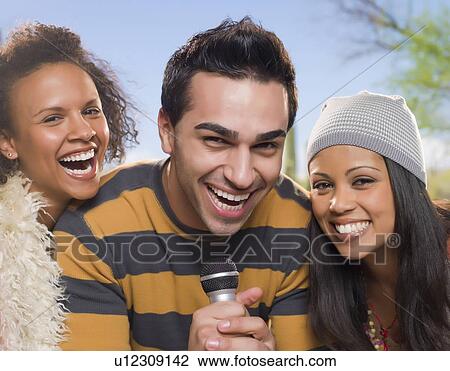Friends singing together outdoors View Large Photo Image Stock Image - Friends singing together outdoors. Fotosearch