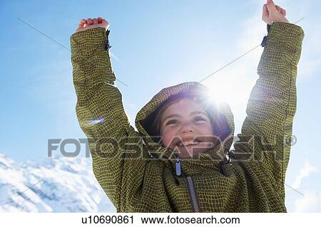 Girl cheering on snowy mountaintop View Large Photo Image Stock Image - Girl cheering on snowy mountaintop. Fotosearch