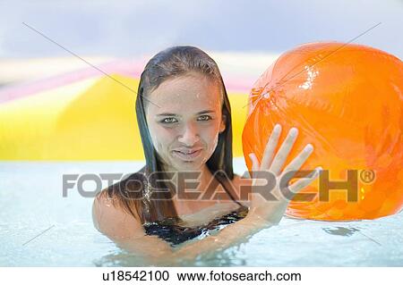 Girl holding inflatable toys in pool View Large Photo Image Stock Image - Girl holding inflatable toys in pool. Fotosearch