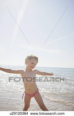 Girl in bikini bottoms on beach View Large Photo Image Picture - Girl in bikini bottoms on beach. Fotosearch