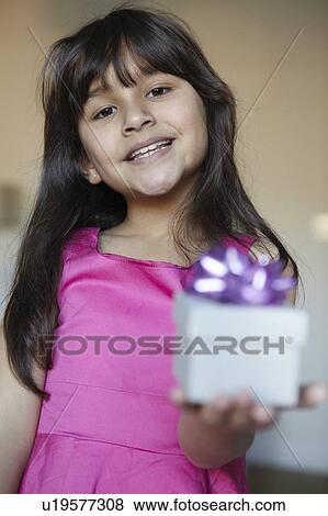 Girl offering wrapped gift View Large Photo Image Stock Photo - Girl offering wrapped gift. Fotosearch