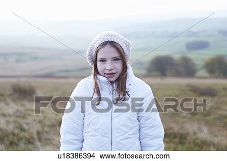 Picture - Girl standing in rural field. Fotosearch