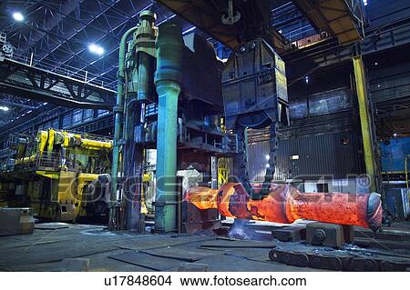 Picture - Glowing machinery in steel forge. Fotosearch