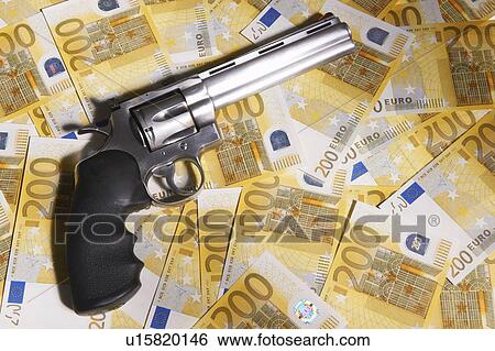 Stock Photograph - Handgun and 200 Euro bills. Fotosearch