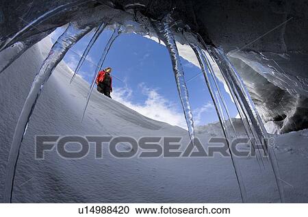 Hiker viewed from glacial cave View Large Photo Image Stock Image - Hiker viewed from glacial cave. Fotosearch