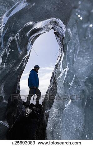 Hiker walking on ice formations View Large Photo Image Stock Photo - Hiker walking on ice formations. Fotosearch