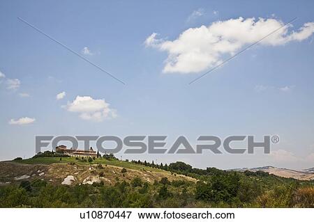 Stock Photo - House on hillside in rural landscape. Fotosearch