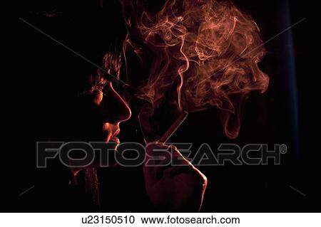 Illuminated profile of woman smoking View Large Photo Image Stock Image - Illuminated profile of woman smoking. Fotosearch