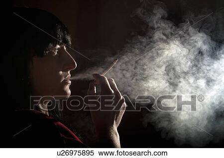 Illuminated profile of woman smoking View Large Photo Image Stock Photography - Illuminated profile of woman smoking. Fotosearch