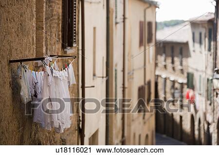 Stock Image - Laundry hanging from apartment window. Fotosearch