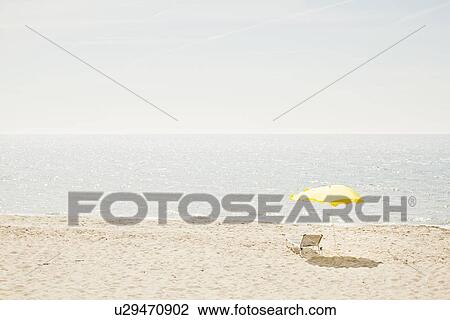 Lawn chair and umbrella on beach View Large Photo Image Stock Image - Lawn chair and umbrella on beach. Fotosearch