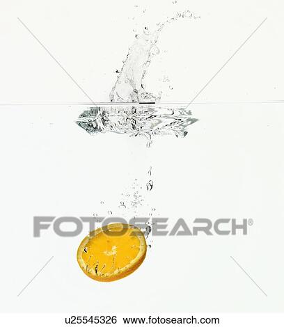 Lemon splashing in water View Large Photo Image Stock Photograph - Lemon splashing in water. Fotosearch