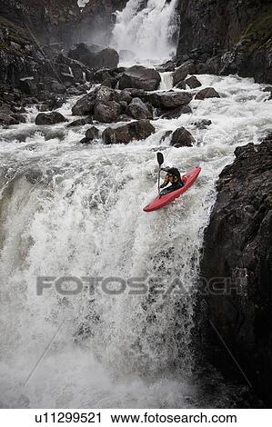 Man canoeing over rocky waterfall View Large Photo Image Stock Image - Man canoeing over rocky waterfall. Fotosearch