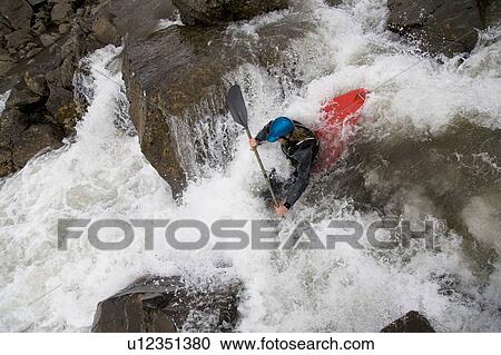 Man canoeing over rocky waterfall View Large Photo Image Stock Image - Man canoeing over rocky waterfall. Fotosearch