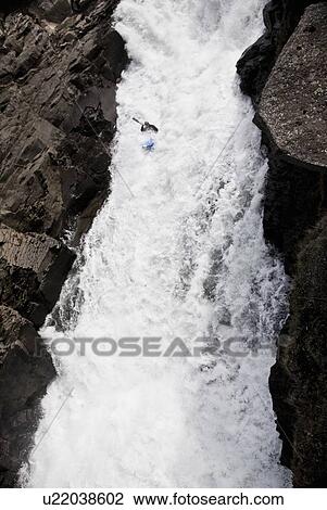 Man canoeing over rocky waterfall View Large Photo Image Stock Image - Man canoeing over rocky waterfall. Fotosearch
