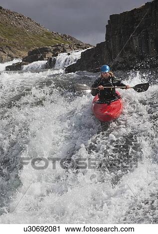 Man canoeing over rocky waterfall View Large Photo Image Stock Image - Man canoeing over rocky waterfall. Fotosearch