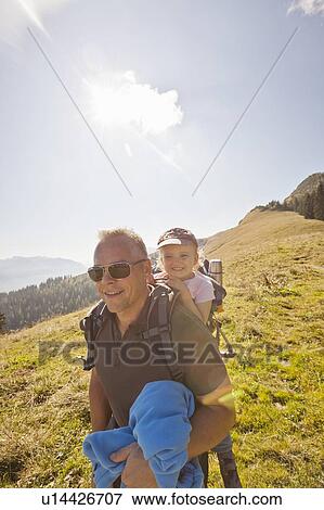 Man carrying daughter on his back View Large Photo Image Stock Photo - Man carrying daughter on his back. Fotosearch