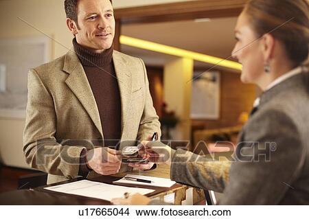 Picture - Man checking in to hotel. Fotosearch