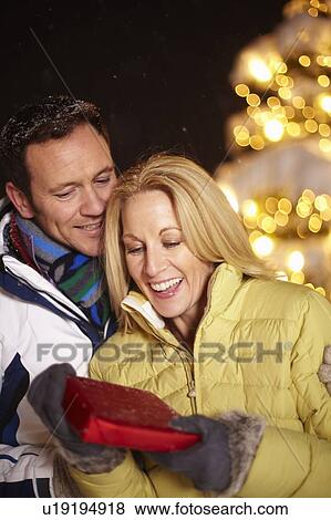 Man giving girlfriend present outdoors View Large Photo Image Stock Photo - Man giving girlfriend present outdoors. Fotosearch