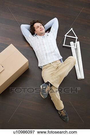 Man laying on floor with boxes View Large Photo Image Stock Photo - Man laying on floor with boxes. Fotosearch