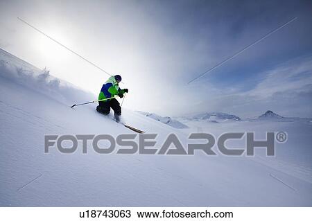 Man skiing on snowy hillside View Large Photo Image Stock Image - Man skiing on snowy hillside. Fotosearch