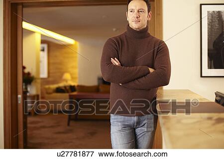 Man standing at hotel front desk View Large Photo Image Stock Photo - Man standing at hotel front desk. Fotosearch