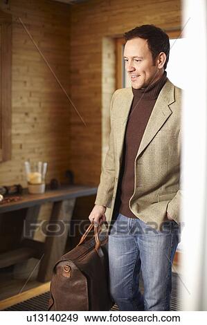 Man walking in hotel lobby View Large Photo Image Stock Photo - Man walking in hotel lobby. Fotosearch