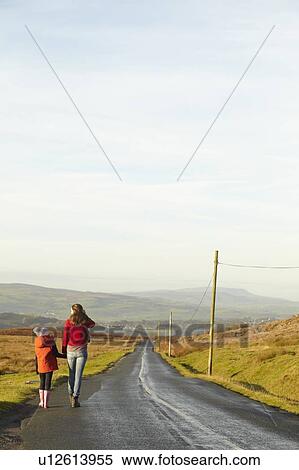 Stock Photography - Mother and daughter on rural road. Fotosearch