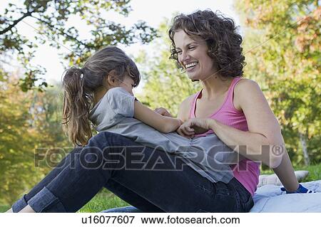 Mother and daughter playing outdoors View Large Photo Image Stock Photo - Mother and daughter playing outdoors. Fotosearch