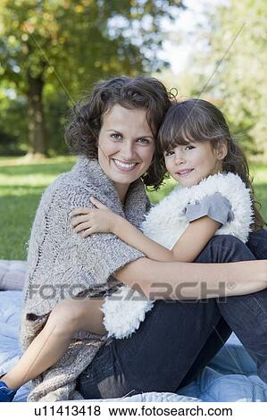 Mother and daughter relaxing on blanket View Large Photo Image Stock Photo - Mother and daughter relaxing on blanket. Fotosearch