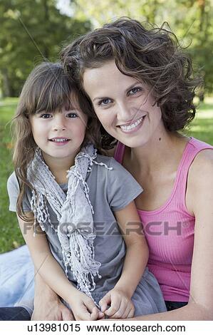 Mother and daughter sitting outdoors View Large Photo Image Stock Photography - Mother and daughter sitting outdoors. Fotosearch