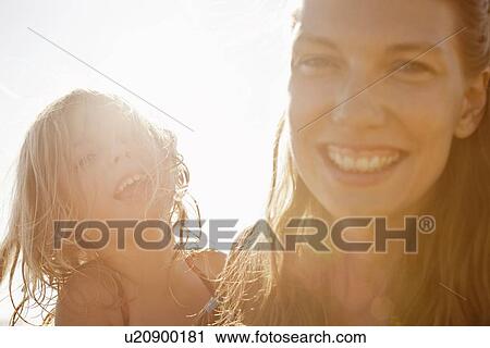 Mother and daughter smiling outdoors View Large Photo Image Stock Image - Mother and daughter smiling outdoors. Fotosearch