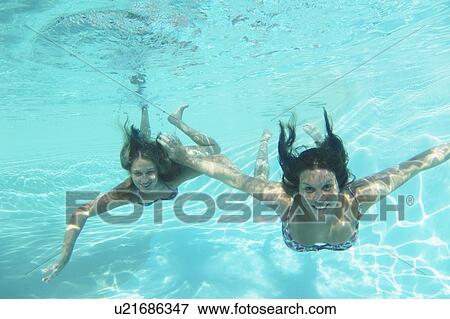 Mother and daughter swimming in pool View Large Photo Image Stock Photo - Mother and daughter swimming in pool. Fotosearch
