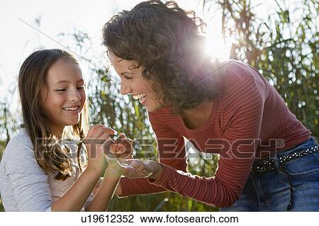 Stock Image - Mother and daughter talking outdoors. Fotosearch